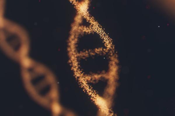 An abstract illustration of a DNA strand made of thousands of tiny particles of light. Another stand is slightly blurred in the background to the left against a black backdrop.