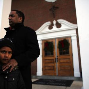 David Echevarria (7) and his father Daniel from Newtown stand outside of a church. Spencer Platt/Getty Images Spencer Platt/Getty Images