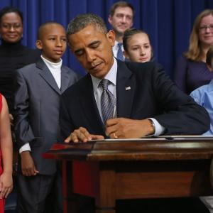 President Obama signs executive orders on new gun law proposals with children. Chip Somodevilla/Getty Images Chip Somodevilla/Getty Images