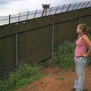 Maryada Vallet stands in Nogales, Mexico, pondering this wall.