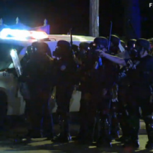 Police march in Ferguson. Image courtesy RNS.