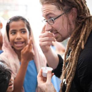 The author visits with children in India, 2010. Image via Facebook. 
