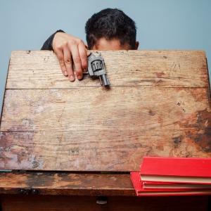 Student with a gun at school, LoloStock / Shutterstock.com