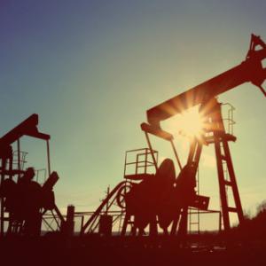 Two working oil pumps are silhouetted against the sky. Photo via Kokhanchikov / Shutterstock / RNS Photo via Kokhanchikov / Shutterstock / RNS