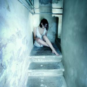 Young woman alone on stairs. Photo courtesy Kati Neudert/shutterstock.com