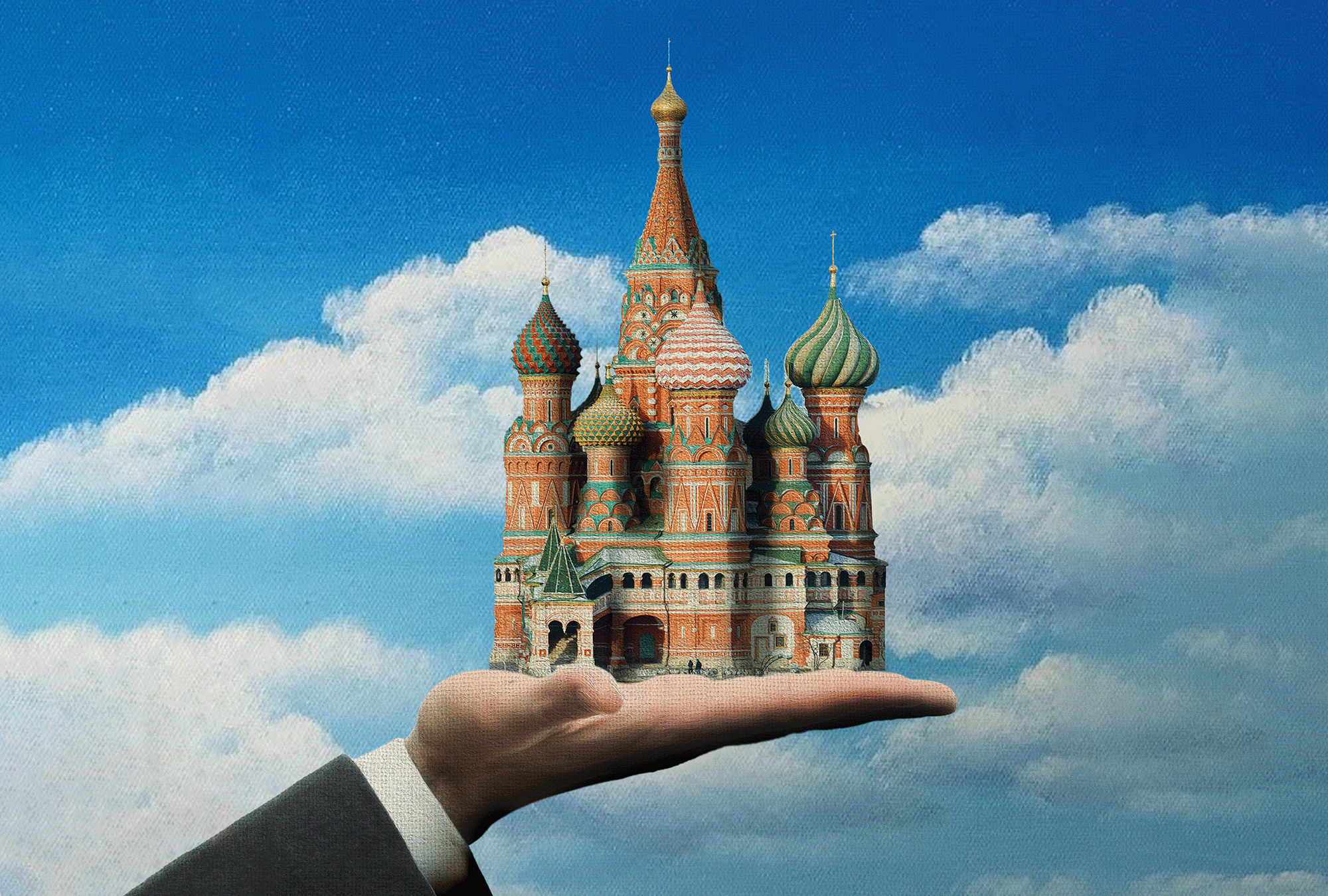 The image shows a hand wearing a priest's robe holding St Basil's Cathedral in Moscow