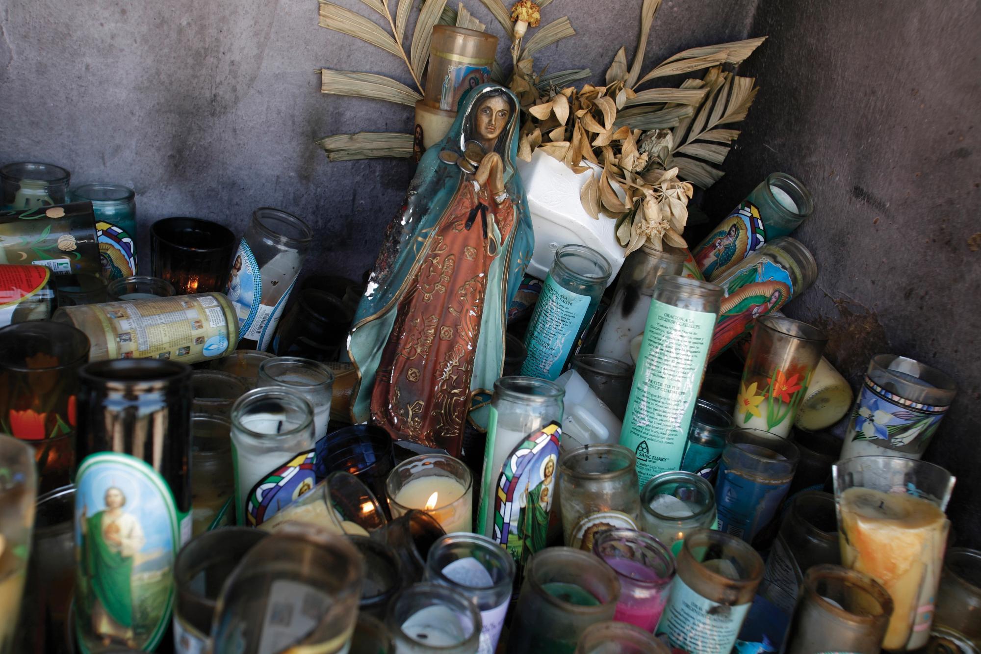Candles and an image of the Virgin of Guadalupe fill a shrine about 60 miles south of the U.S.-Mexico border.