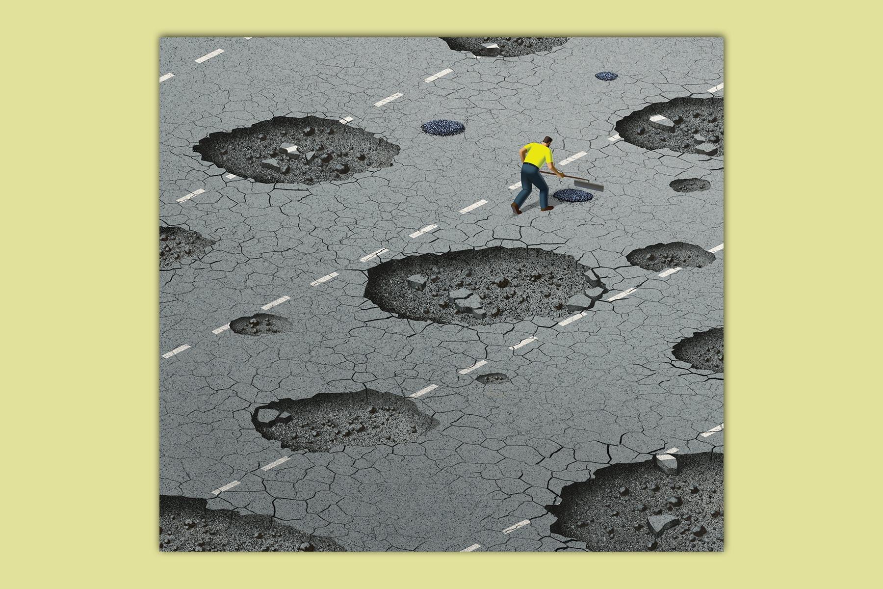 A man in a yellow shirt filling in a pot hole.