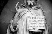 A statue of Jesus holding the a book imprinted with Luke 4:18. Photo courtesy of BleColRob/RNS.