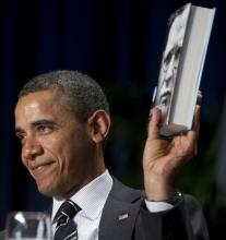 President Obama holds a copy of a Dietrich Bonhoeffer biography at the National Prayer Breakfast, 2/2/12. Photo by Getty Images Obama at the National Prayer Breakfast. Image by Getty Images.