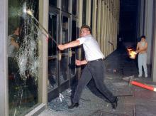 A rioter breaks a glass door of the Criminal Courts building, downtown Los Angeles, 29 April 1992. HAL GARB/AFP/Getty Images HAL GARB/AFP/Getty Images