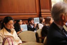Protesters hold signs during climate change testimonies before the EPA. Photo: Joey Longley/Sojourners