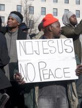 A protester holds a sign at the Justice for All march on Saturday in Washington.
