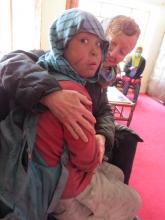 Kathy Kelly with Safar, an Afghan “street child” Kathy Kelly with Safar, an Afghan “street child”