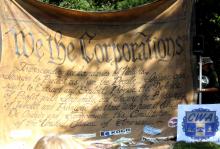 "We the Corporations" sign at protest outside the TPP negotiations