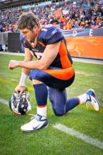 Tim Tebow taking a knee. Photo Courtesy RNS/Wikipedia Photo Courtesy RNS/Wikipedia