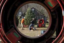 The photo, taken through the middle Christmas tree bailer, shows two men lifting up a Christmas tree