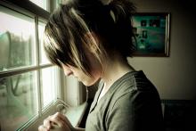 A young woman in prayer. Image via Wylio. A young woman in prayer. Image via Wylio.