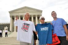 Opponents of SB 1070 stand outside the Supreme Court as the decision is handed down. Ivone Guillen / Sojourners Ivone Guillen / Sojourners
