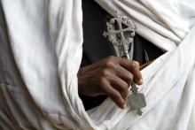 Hand holding Coptic cross.