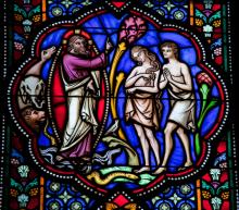 Stained glass window depicting Adam & Eve, jorisvo / Shutterstock.com