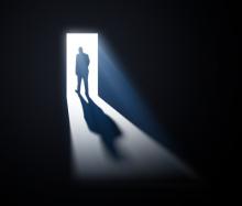 man walking through open doors, Mopic / Shutterstock.com