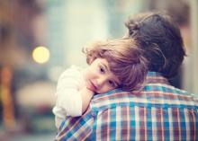 Little girl resting on her father's shoulder. Photo via Dina Uretski/Shutterstock.