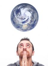 Man praying for the earth, Gandolfo Cannatella / Shutterstock.com