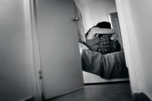 Traumatized women sit on a bed in a bedroom. ChameleonsEye / Shutterstock.com ChameleonsEye / Shutterstock.com
