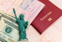 Passport visa and money. Image courtesy mariakraynova/shutterstock.com.