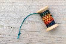 Spool of old thread. Image via TAGSTOCK1/shutterstock.com