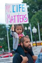 A young girl joins a rally against racism in Washington, DC in August 2014. Imag