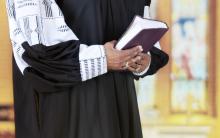 Female clergy holding a Bible, glenda / Shutterstock.com Female clergy holding a Bible, glenda / Shutterstock.com