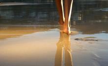 Walking on a beach. Image via mimagephotography/shutterstock.com