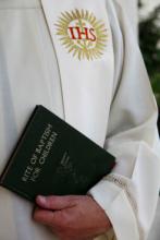 A priest prepares for a baptism. Photo courtesy of DainaFalk via Shutterstock