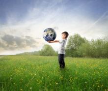 Child holding the earth, olly, Shutterstock.com