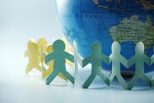Paper chain surrounding the globe. discpicture / Shutterstock discpicture / Shutterstock