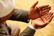 Hands with Muslim prayer beads, Omer N Raja / Shutterstock.com
