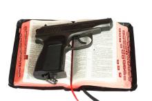 Religion and gun photo,  sagasan / Shutterstock.com