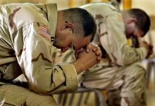 Two U.S. Army Chaplains bow their heads in prayer during an Easter service. Photo via REUTERS / Adrees Latif / RNS Photo via REUTERS / Adrees Latif / RNS