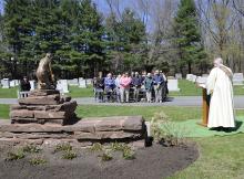 Deacon Jim O'Rourke speaks at a memorial service at Most Holy Redeemer Cemetery. Photo via Hans Pennink / RNS Photo via Hans Pennink / RNS