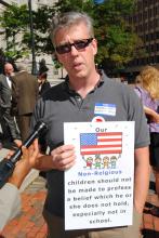 Andrew Hall, an atheist and father, demonstrates outside the Massachusetts Supreme Court. Photo by G. Jeffrey MacDonald.