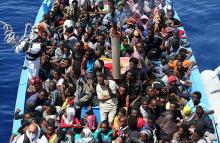 Three hundred sub-Saharan Africans sit onboard a boat during a rescue operation. Photo courtesy of REUTERS/Alessandro Bianchi Photo courtesy of REUTERS/Alessandro Bianchi