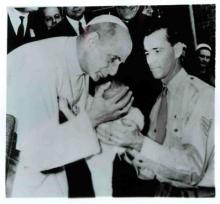 During a visit in Sydney, Pope Paul VI bends to kiss a baby. Religion News Service file photo.