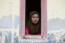 A Rohingya migrant woman inside a compound for refugees in Indonesia’s Aceh Province. Photo via REUTERS / Beawiharta / RNS Photo via REUTERS / Beawiharta / RNS
