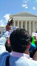 A man holds up a Bible in front of the Supreme Court. Photo via Kevin Eckstrom / RNS Photo via Kevin Eckstrom / RNS