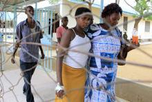 A woman is escorted to the wards after hiding for three days at her university in Garissa. Photo via REUTERS / Noor Khamis / RNS Photo via REUTERS / Noor Khamis / RNS