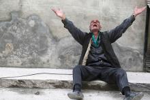 A man reacts to a bomb in Aleppo’s al-Fardous district on April 29, 2015. Photo via REUTERS / Hosam Katan / RNS Photo via REUTERS / Hosam Katan / RNS
