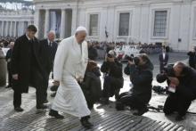 Pope Francis passes news photographers in St. Peter’s Square. Photo by Paul Haring, courtesy of Catholic News Service