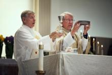 Deacon Joe Krysiak, left, is shown here during Holy Communion in Baltimore. RNS Photo by by Dennis Drenner RNS Photo by by Dennis Drenner